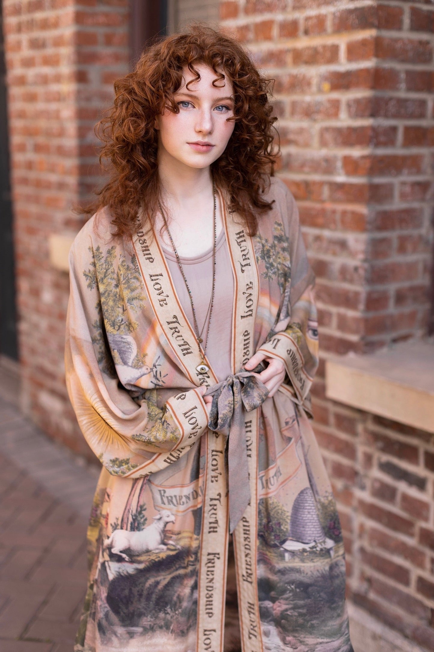 Model wearing sun-washed vintage-inspired Opera Duster featuring symbols of friendship, love, and truth in soft lavender, sage, gold, and aqua – Market of Stars