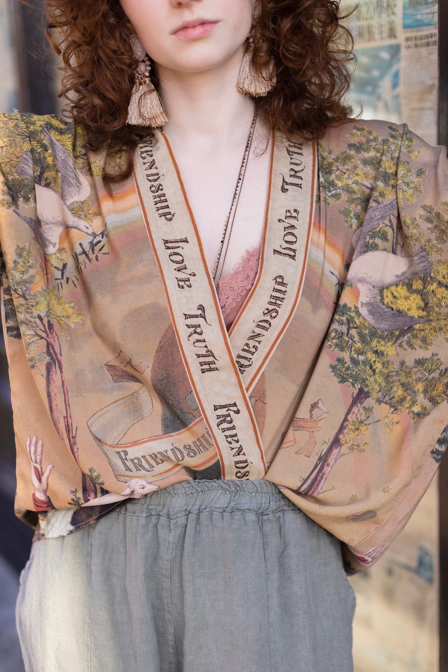 Vintage-inspired cropped kimono featuring historic symbols of friendship, love, and truth in a soft sun-washed palette of lavender, sage, gold, and aqua – Market of Stars.