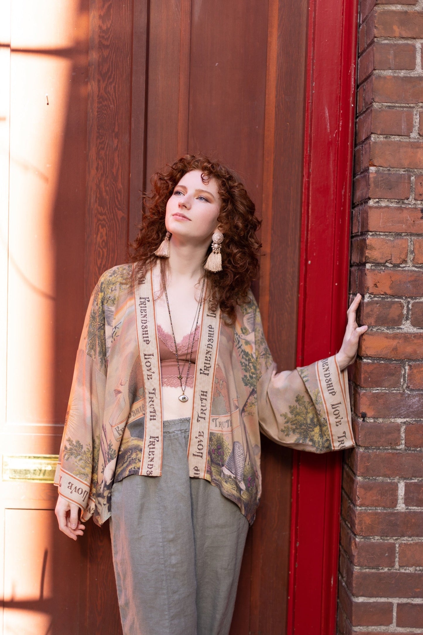 Vintage-inspired cropped kimono featuring historic symbols of friendship, love, and truth in a soft sun-washed palette of lavender, sage, gold, and aqua – Market of Stars.