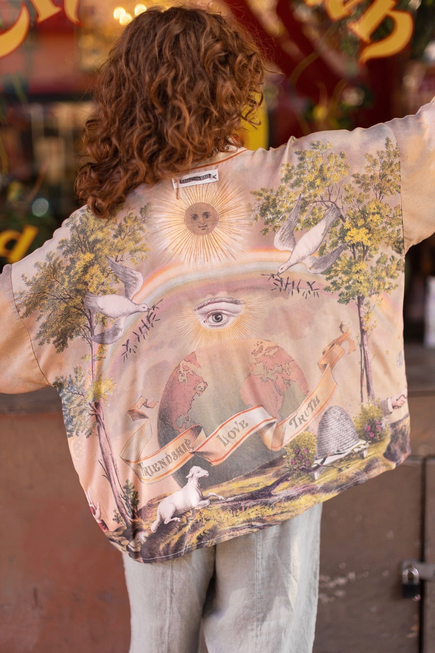 Vintage-inspired cropped kimono featuring historic symbols of friendship, love, and truth in a soft sun-washed palette of lavender, sage, gold, and aqua – Market of Stars.