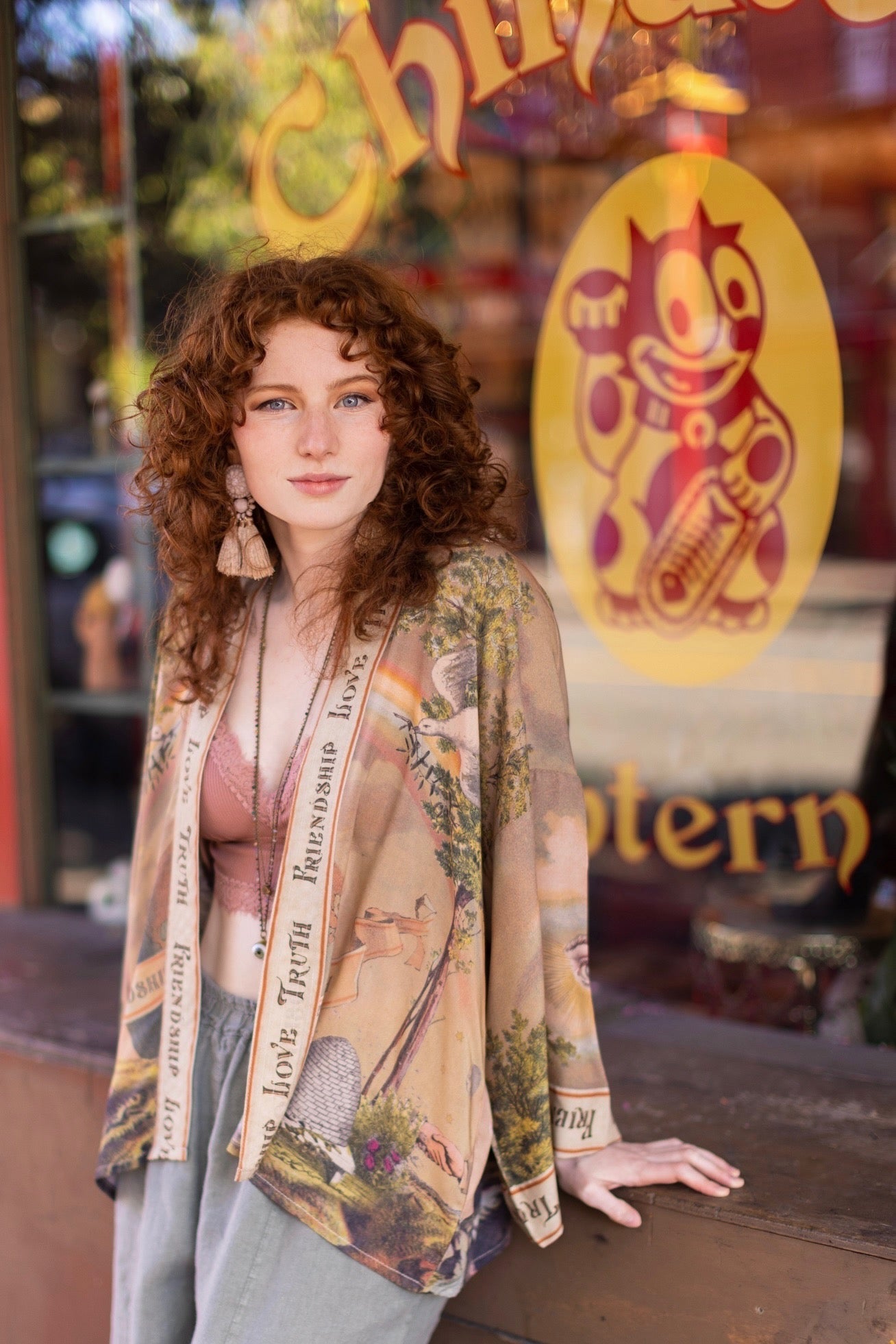 Vintage-inspired cropped kimono featuring historic symbols of friendship, love, and truth in a soft sun-washed palette of lavender, sage, gold, and aqua – Market of Stars.