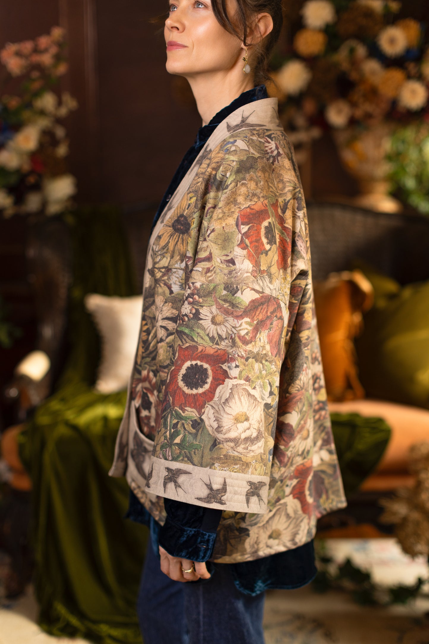 Model wearing a soft fleece cottage cardigan featuring rich 1700s botanical blooms and swallow trim - Market of Stars