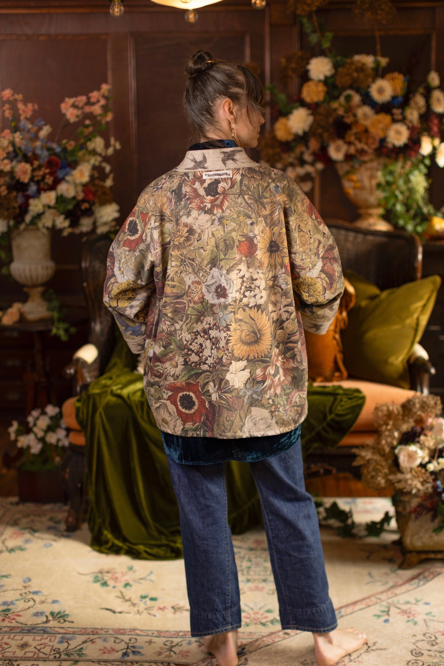 Model wearing a soft fleece cottage cardigan featuring rich 1700s botanical blooms and swallow trim - Market of Stars
