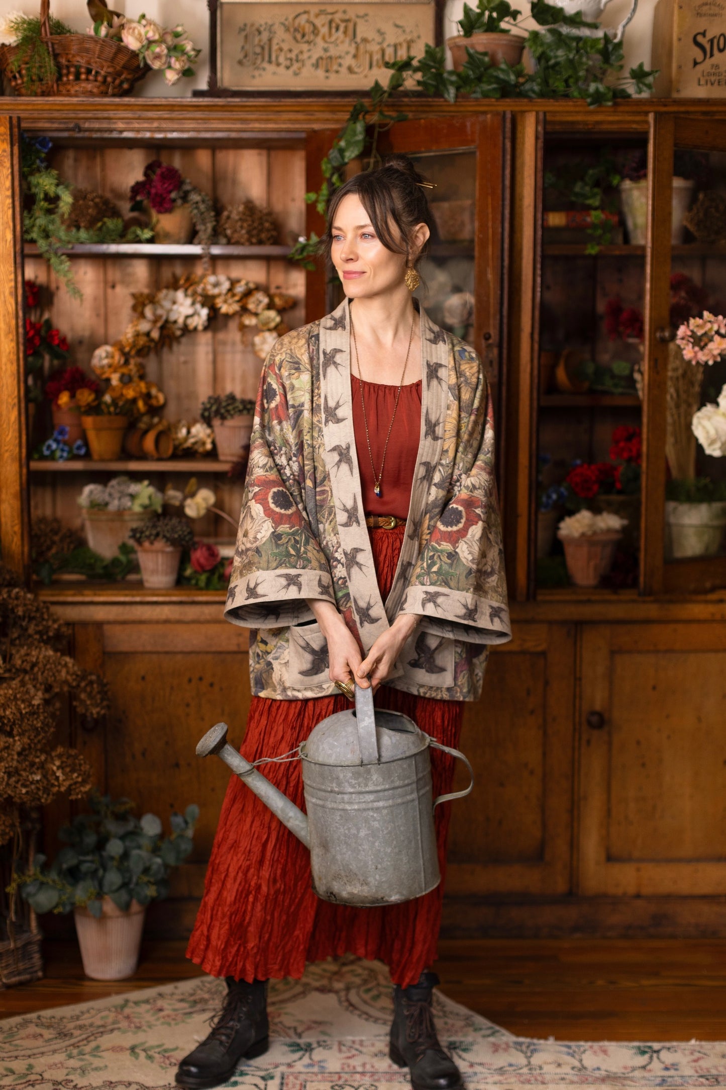 Model wearing a soft fleece cottage cardigan featuring rich 1700s botanical blooms and swallow trim - Market of Stars
