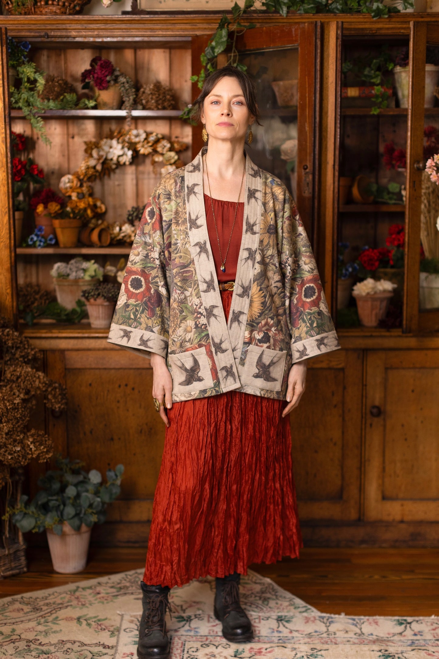 Model wearing a soft fleece cottage cardigan featuring rich 1700s botanical blooms and swallow trim - Market of Stars