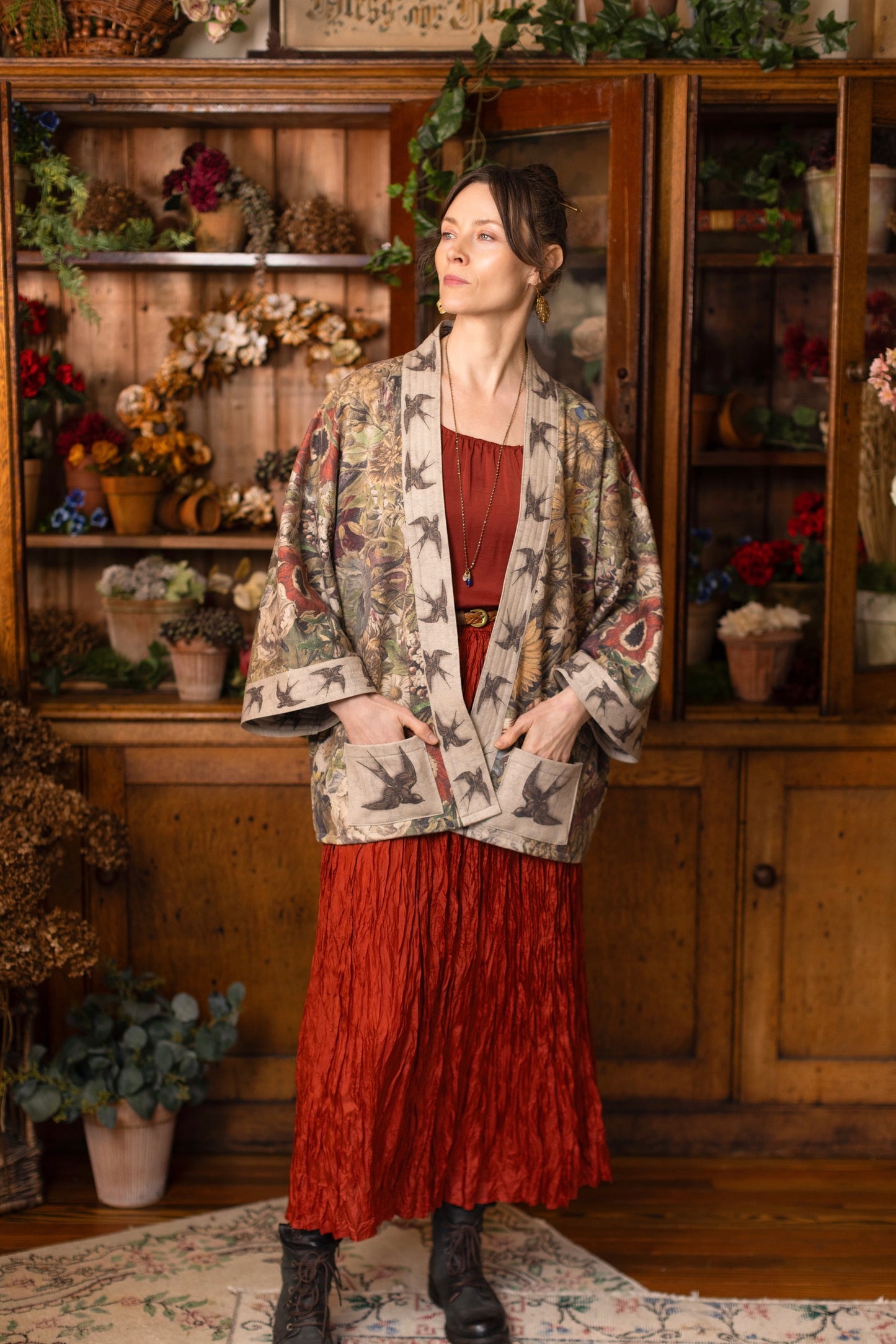 Model wearing a soft fleece cottage cardigan featuring rich 1700s botanical blooms and swallow trim - Market of Stars
