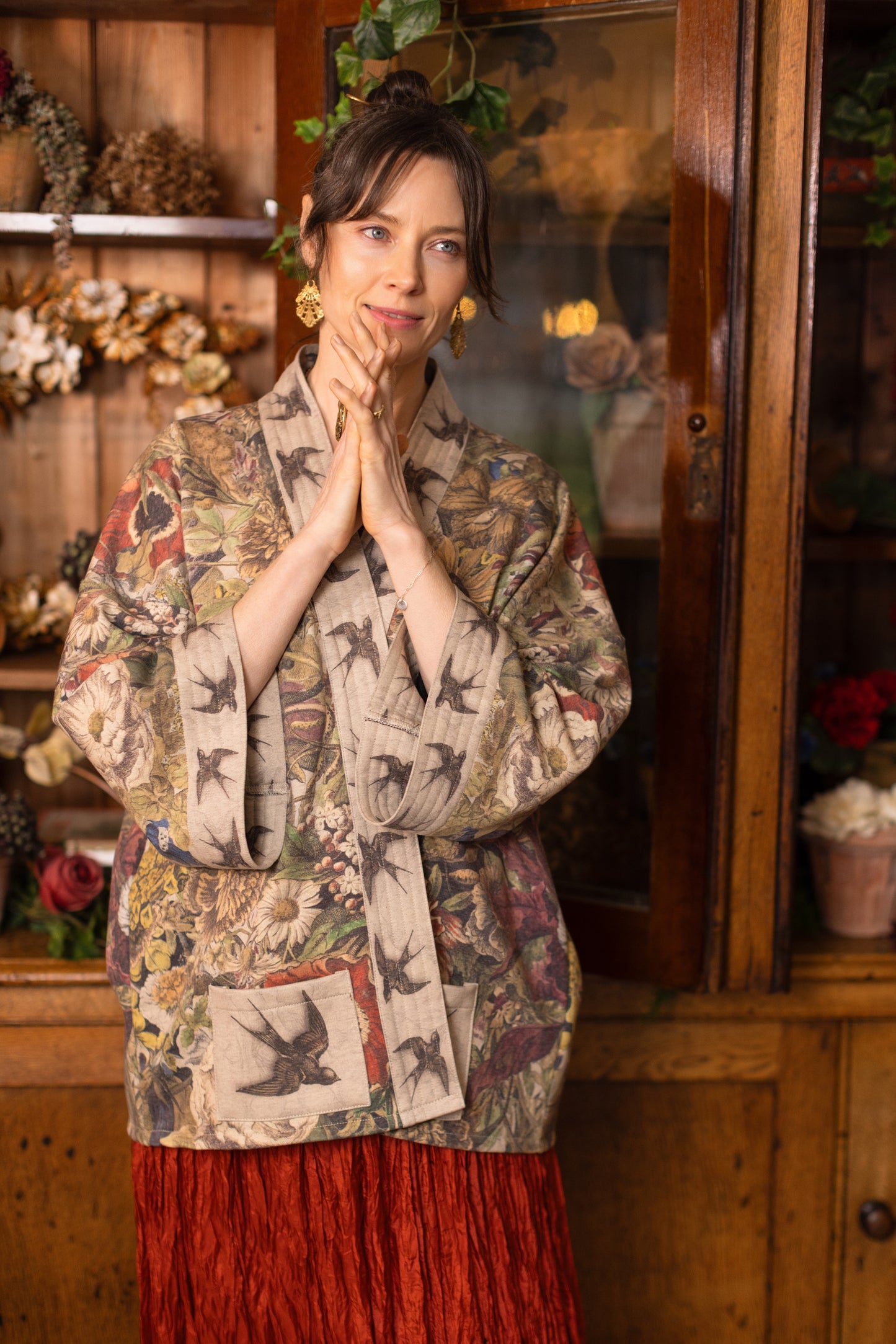 Model wearing a soft fleece cottage cardigan featuring rich 1700s botanical blooms and swallow trim - Market of Stars