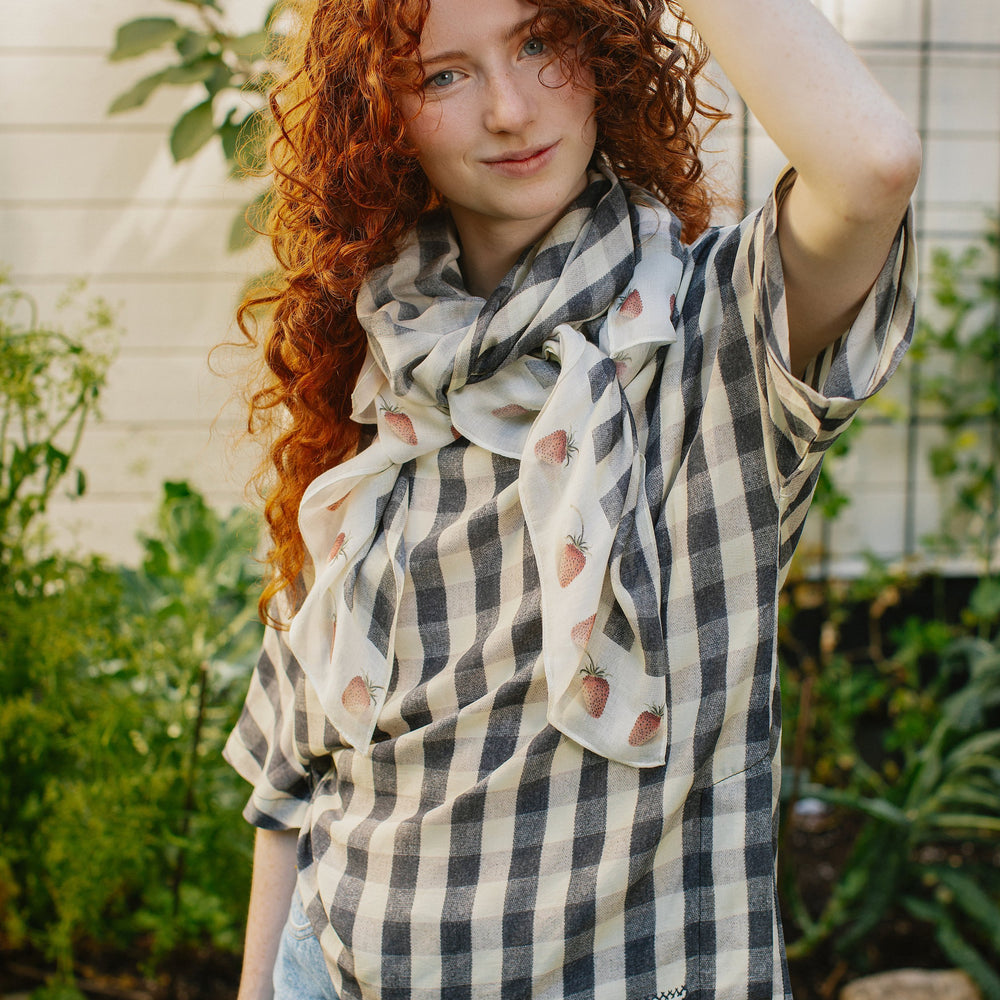 Model wearing Happy Days scarf featuring heritage gingham, vintage strawberries, and a cross-stitch patch inspired by an 1836 sampler – Market of Stars.