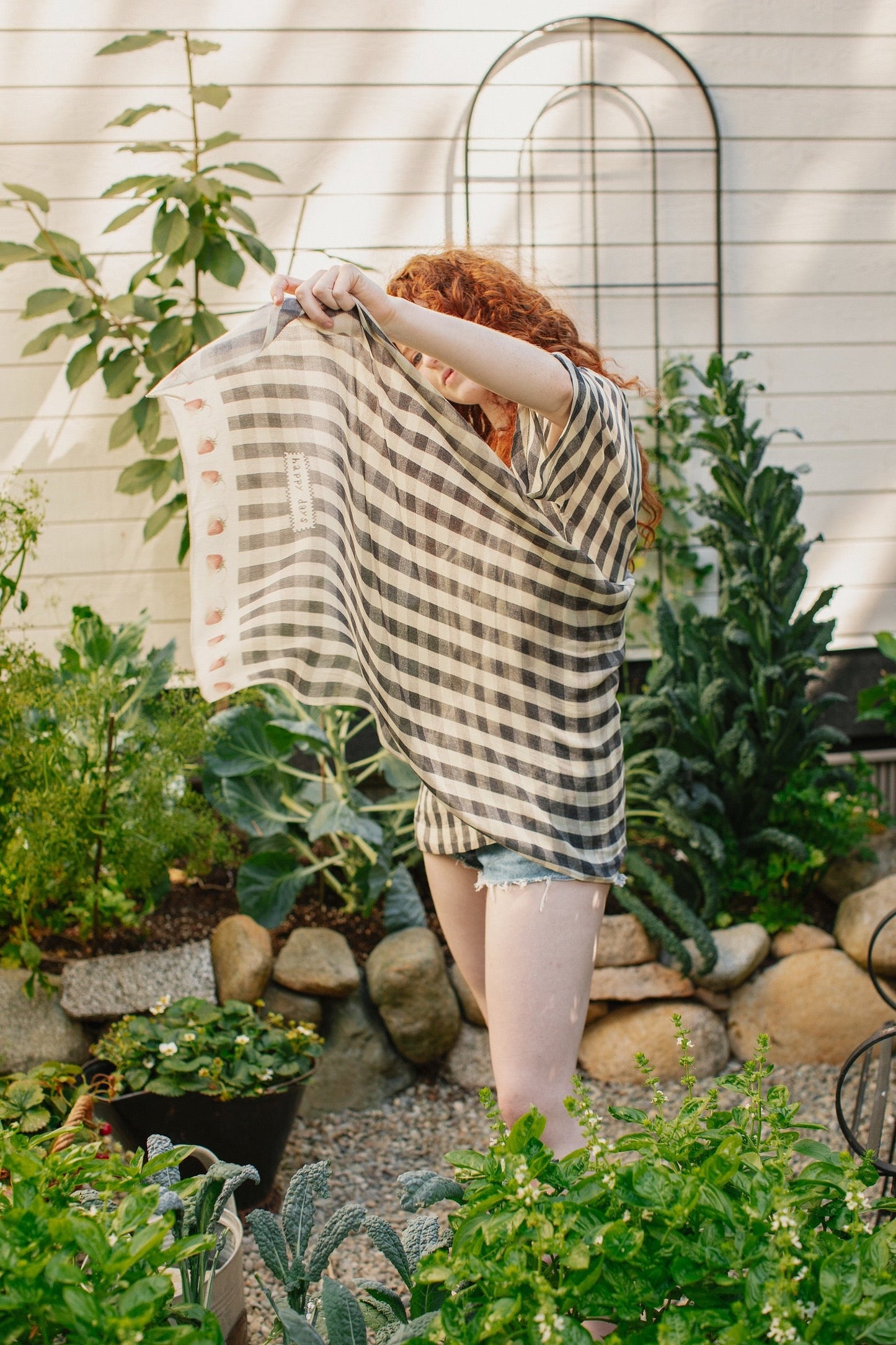 Model wearing Happy Days scarf featuring heritage gingham, vintage strawberries, and a cross-stitch patch inspired by an 1836 sampler – Market of Stars.