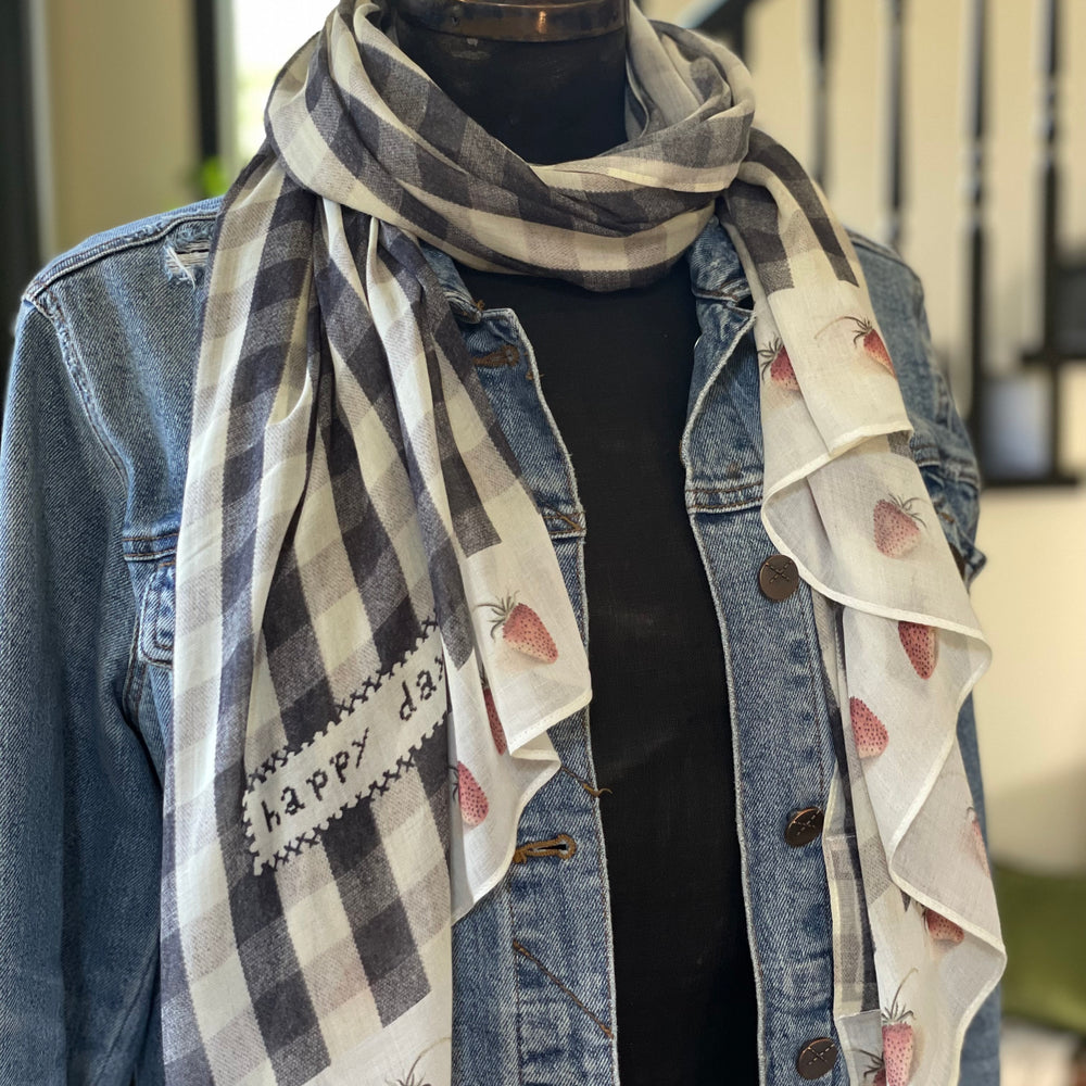 
                  
                    Model wearing Happy Days scarf featuring heritage gingham, vintage strawberries, and a cross-stitch patch inspired by an 1836 sampler – Market of Stars.
                  
                