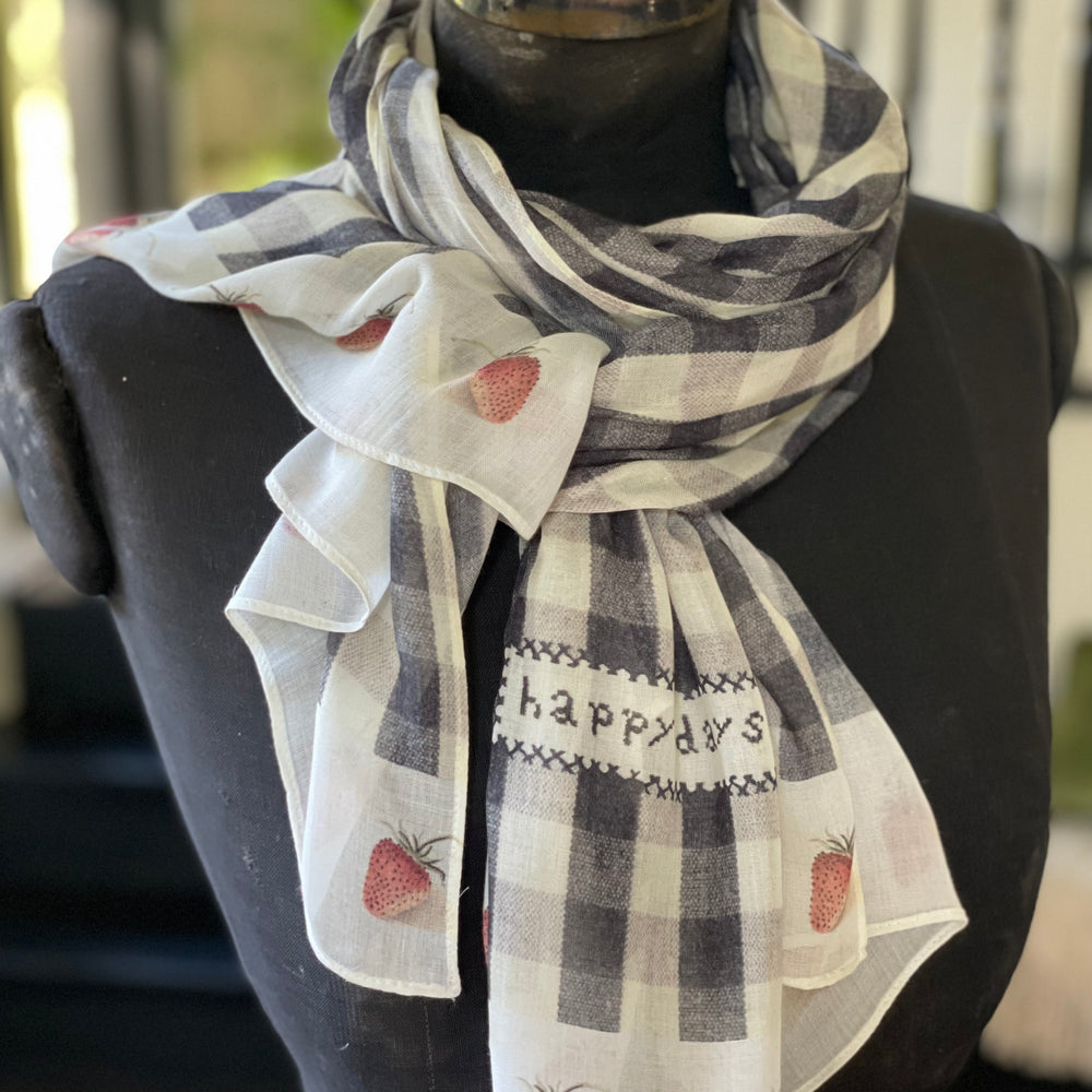 
                  
                    Model wearing Happy Days scarf featuring heritage gingham, vintage strawberries, and a cross-stitch patch inspired by an 1836 sampler – Market of Stars.
                  
                