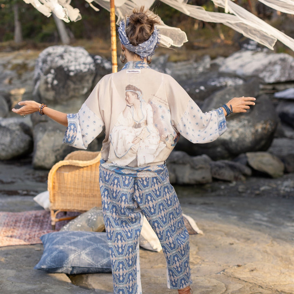 
                  
                    Model wearing Head in the Clouds Artist Pants featuring starry front panel and Turkish rug trim from Liotard’s portrait The Painter’s Wife-Market of Stars
                  
                