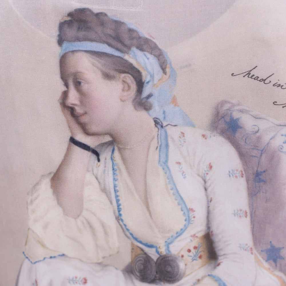 
                  
                    Model wearing the Head in the Clouds Opera Duster featuring Liotard’s portrait of his wife with Turkish textiles, starry sleeves, and poetic script – Market of Stars.
                  
                