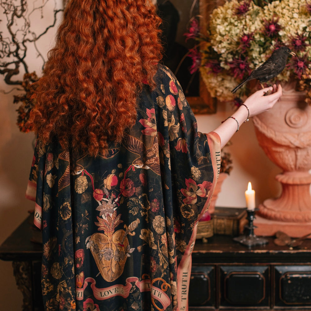 Model wearing a flowy bamboo-viscose duster featuring a collage of antique artwork with romance, loyalty, and old-world beauty - Market of Stars
