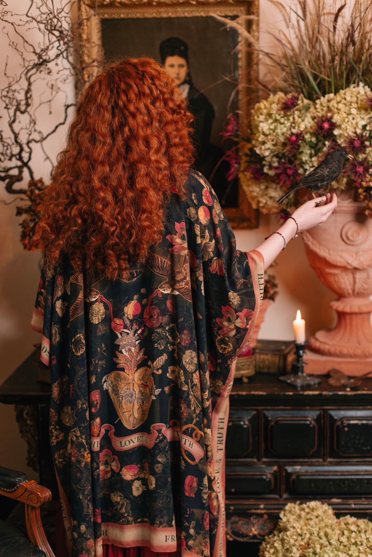 Model wearing a flowy bamboo-viscose duster featuring a collage of antique artwork with romance, loyalty, and old-world beauty - Market of Stars