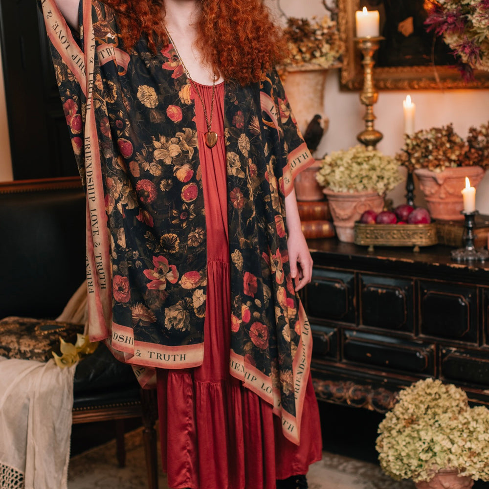 
                  
                    Model wearing a flowy bamboo-viscose duster featuring a collage of antique artwork with romance, loyalty, and old-world beauty - Market of Stars
                  
                