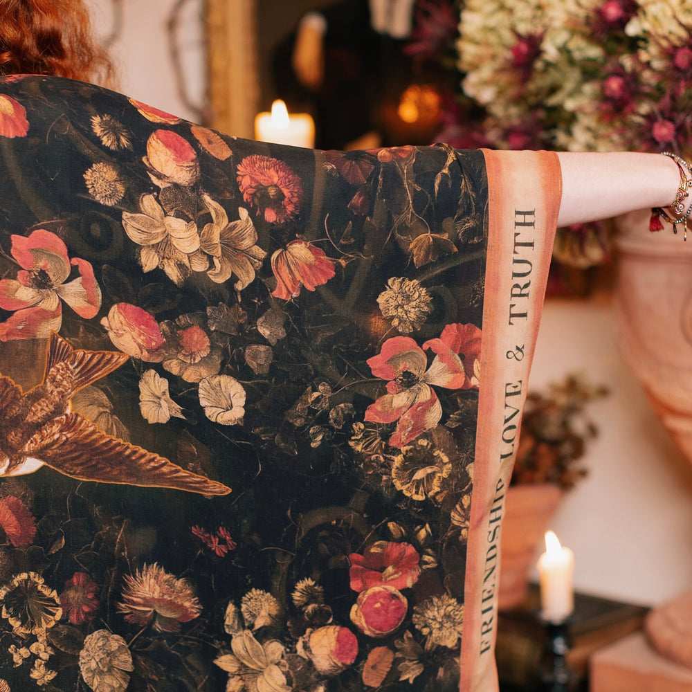 
                  
                    Model wearing a flowy bamboo-viscose duster featuring a collage of antique artwork with romance, loyalty, and old-world beauty - Market of Stars
                  
                