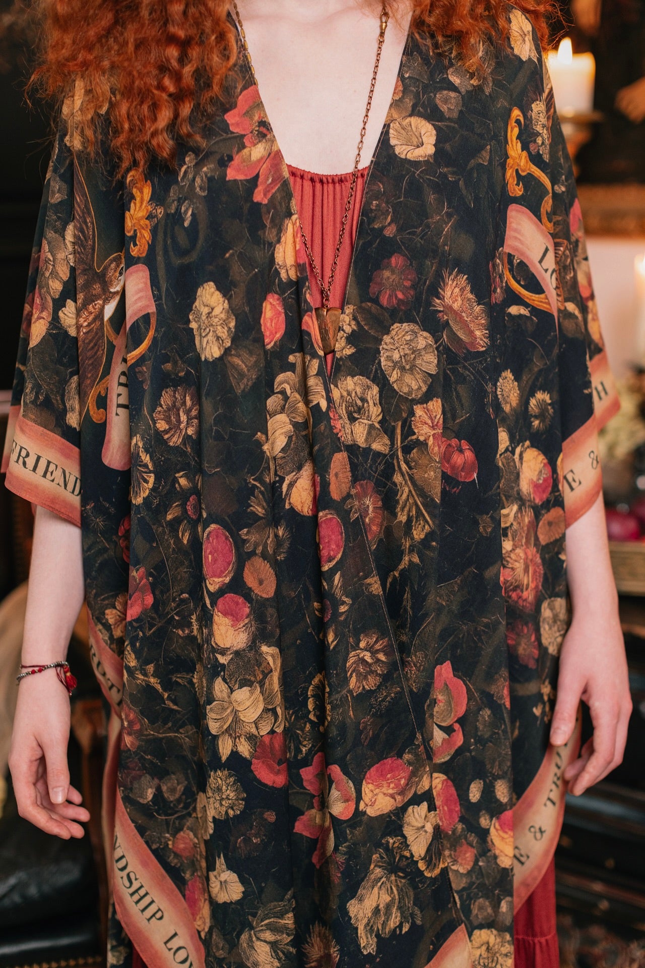 Model wearing a flowy bamboo-viscose duster featuring a collage of antique artwork with romance, loyalty, and old-world beauty - Market of Stars