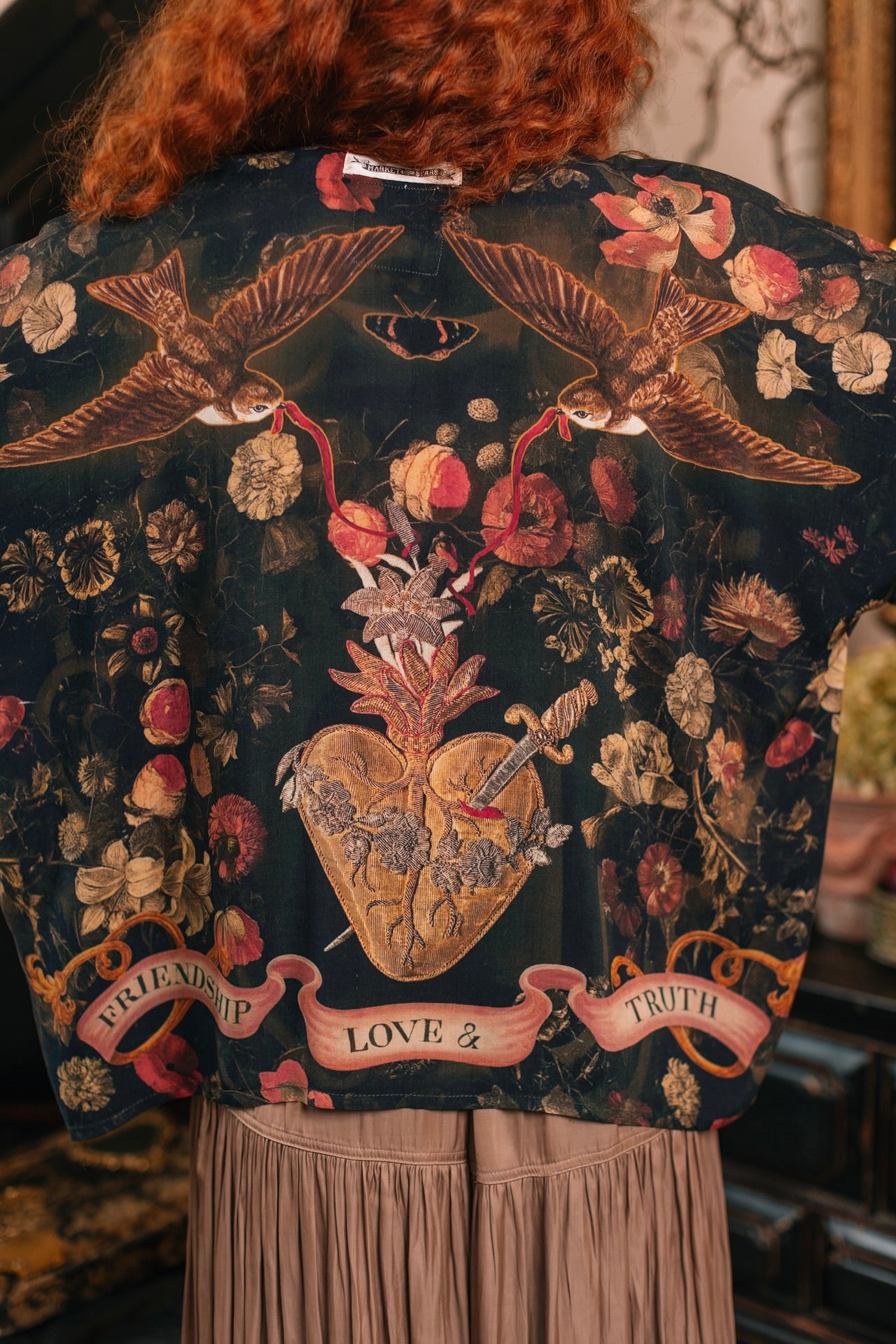 Model wearing a cropped-length bamboo-viscose duster featuring a collage of antique artwork with romance, loyalty, and old-world beauty - Market of Stars