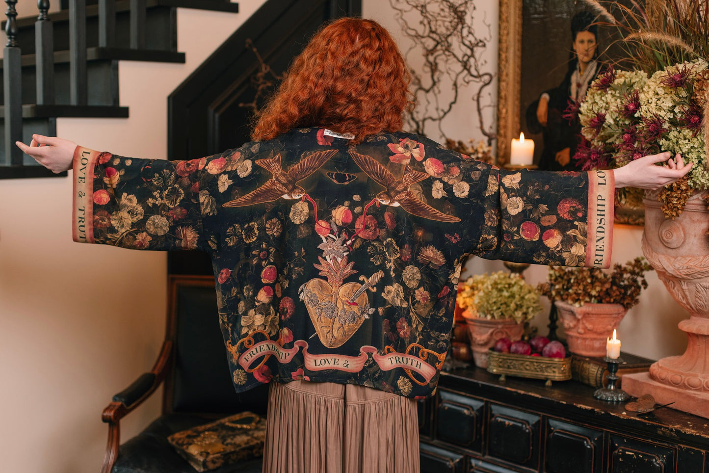 Model wearing a cropped-length bamboo-viscose duster featuring a collage of antique artwork with romance, loyalty, and old-world beauty - Market of Stars