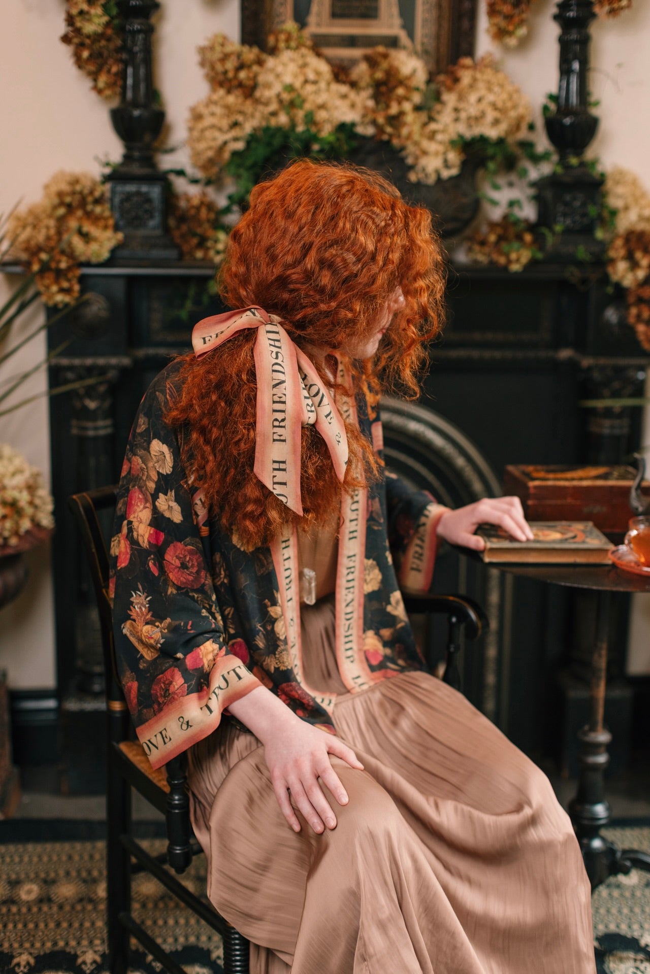Model wearing a cropped-length bamboo-viscose duster featuring a collage of antique artwork with romance, loyalty, and old-world beauty - Market of Stars
