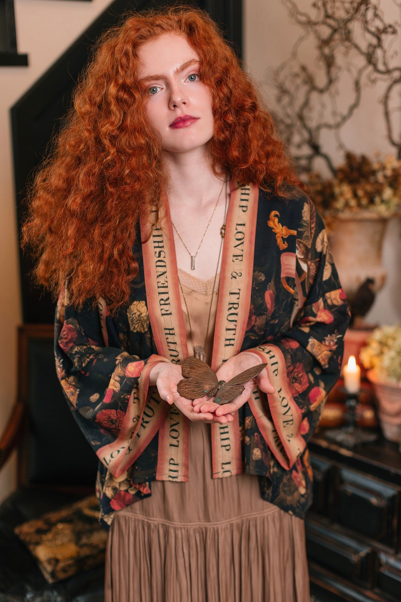 Model wearing a cropped-length bamboo-viscose duster featuring a collage of antique artwork with romance, loyalty, and old-world beauty - Market of Stars