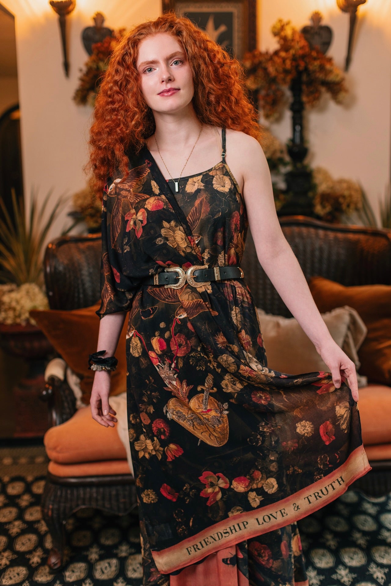 Model wearing a bamboo-viscose scarf featuring a collage of antique artwork that celebrates the bonds in our lives that endure — love, truth, and loyal friends!