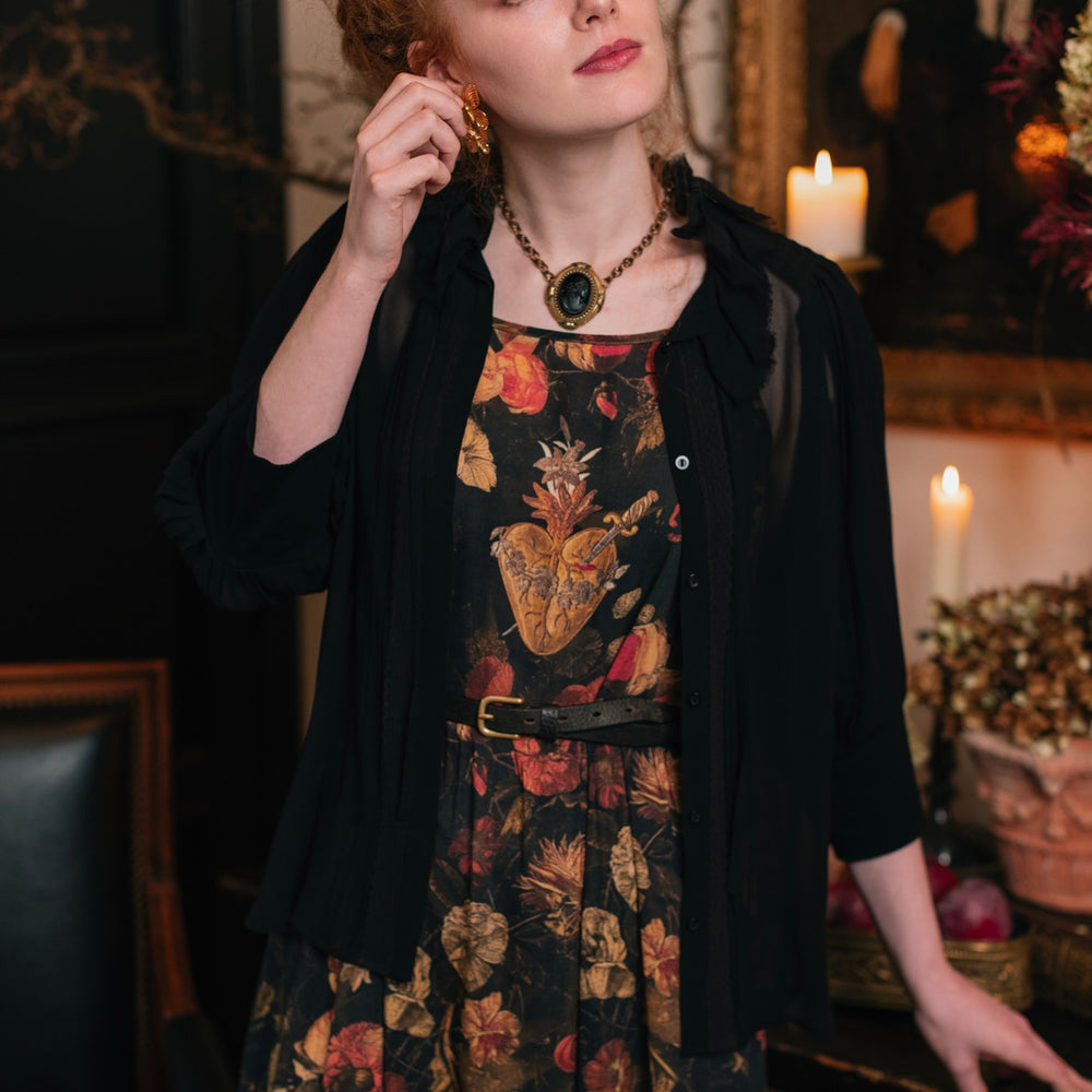 
                  
                    Model wearing a maxi-length bamboo-viscose slip dress featuring a collage of antique artwork with romance, loyalty, and old-world beauty - Market of Stars
                  
                