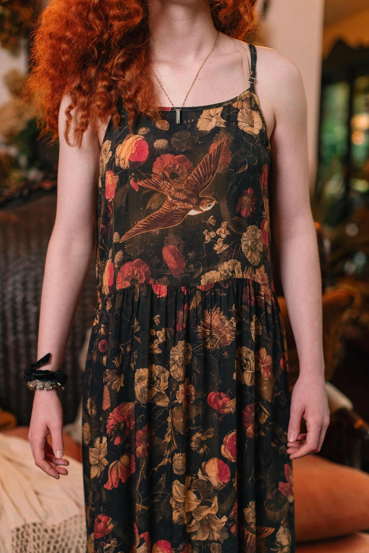 Model wearing a maxi-length bamboo-viscose slip dress featuring a collage of antique artwork with romance, loyalty, and old-world beauty - Market of Stars