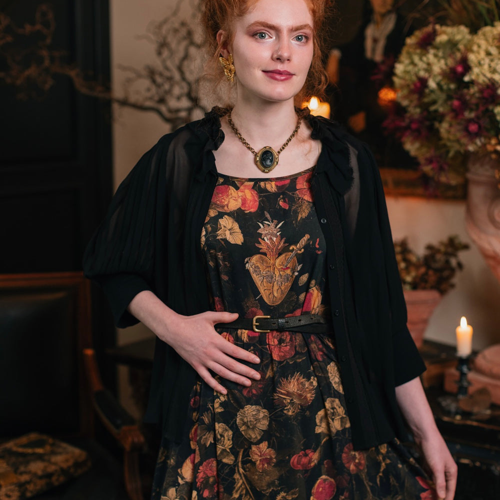 
                  
                    Model wearing a maxi-length bamboo-viscose slip dress featuring a collage of antique artwork with romance, loyalty, and old-world beauty - Market of Stars
                  
                