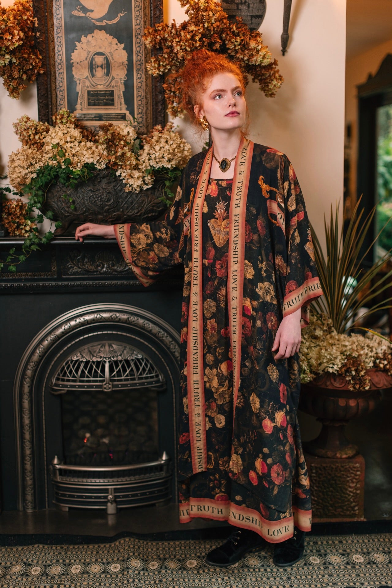 Model wearing a maxi-length bamboo-viscose slip dress featuring a collage of antique artwork with romance, loyalty, and old-world beauty - Market of Stars