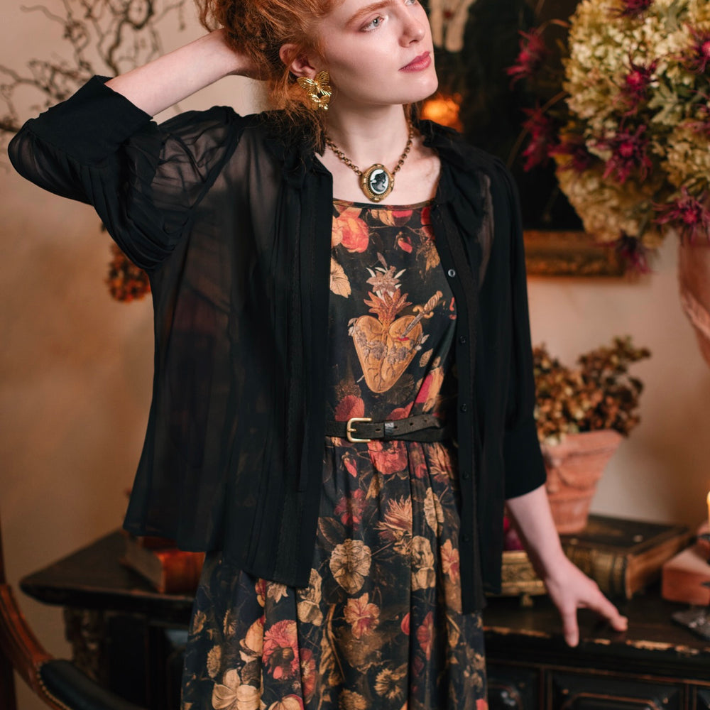 
                  
                    Model wearing a maxi-length bamboo-viscose slip dress featuring a collage of antique artwork with romance, loyalty, and old-world beauty - Market of Stars
                  
                