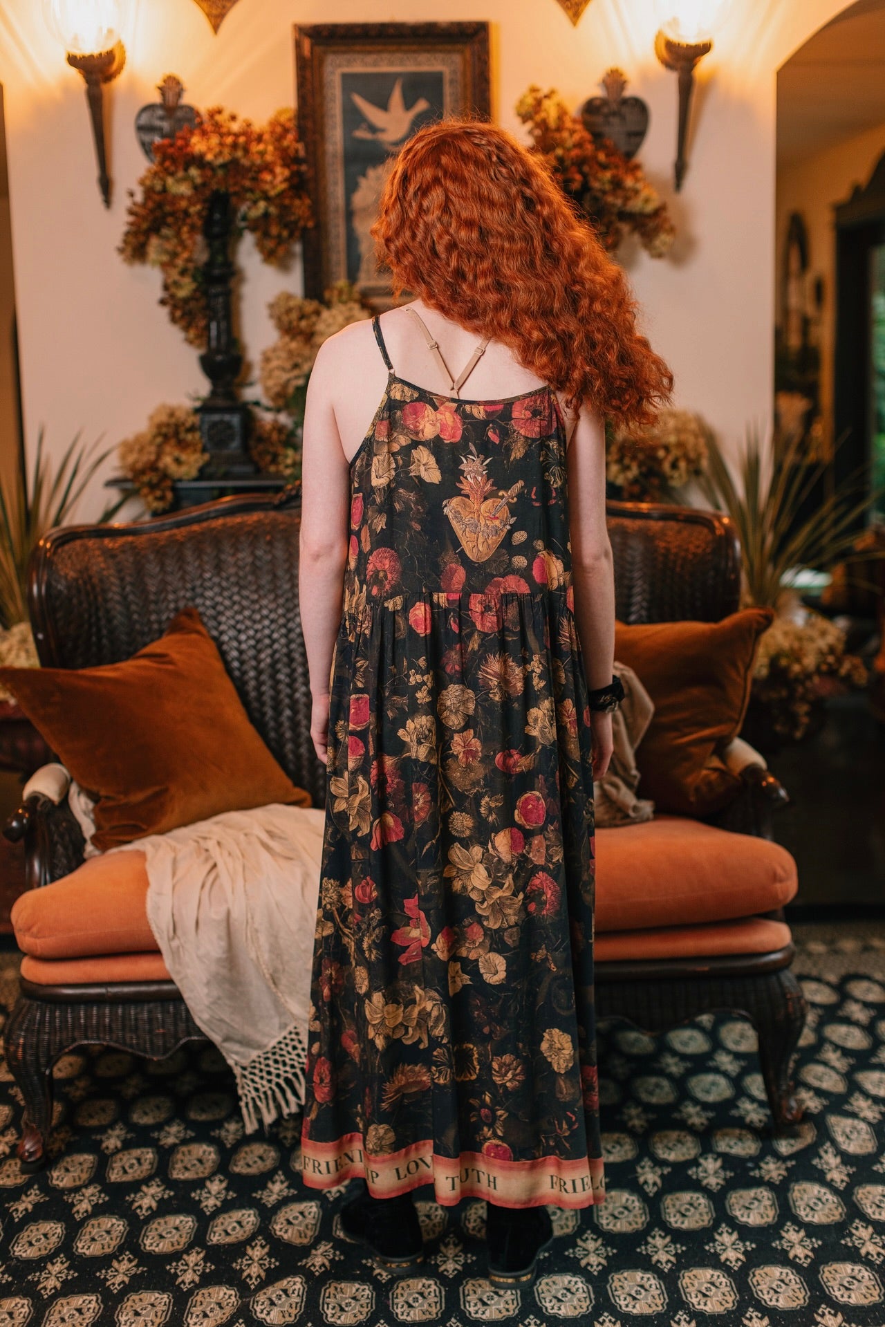Model wearing a maxi-length bamboo-viscose slip dress featuring a collage of antique artwork with romance, loyalty, and old-world beauty - Market of Stars