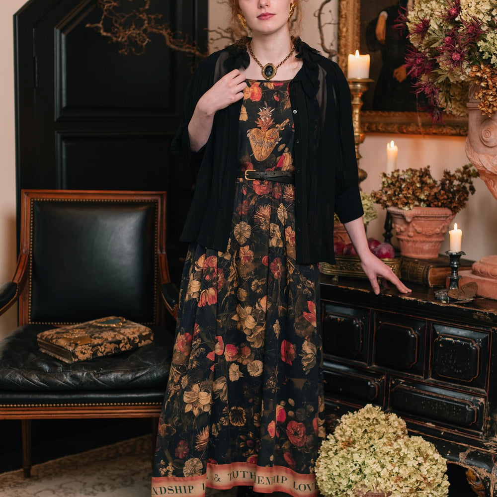 
                  
                    Model wearing a maxi-length bamboo-viscose slip dress featuring a collage of antique artwork with romance, loyalty, and old-world beauty - Market of Stars
                  
                