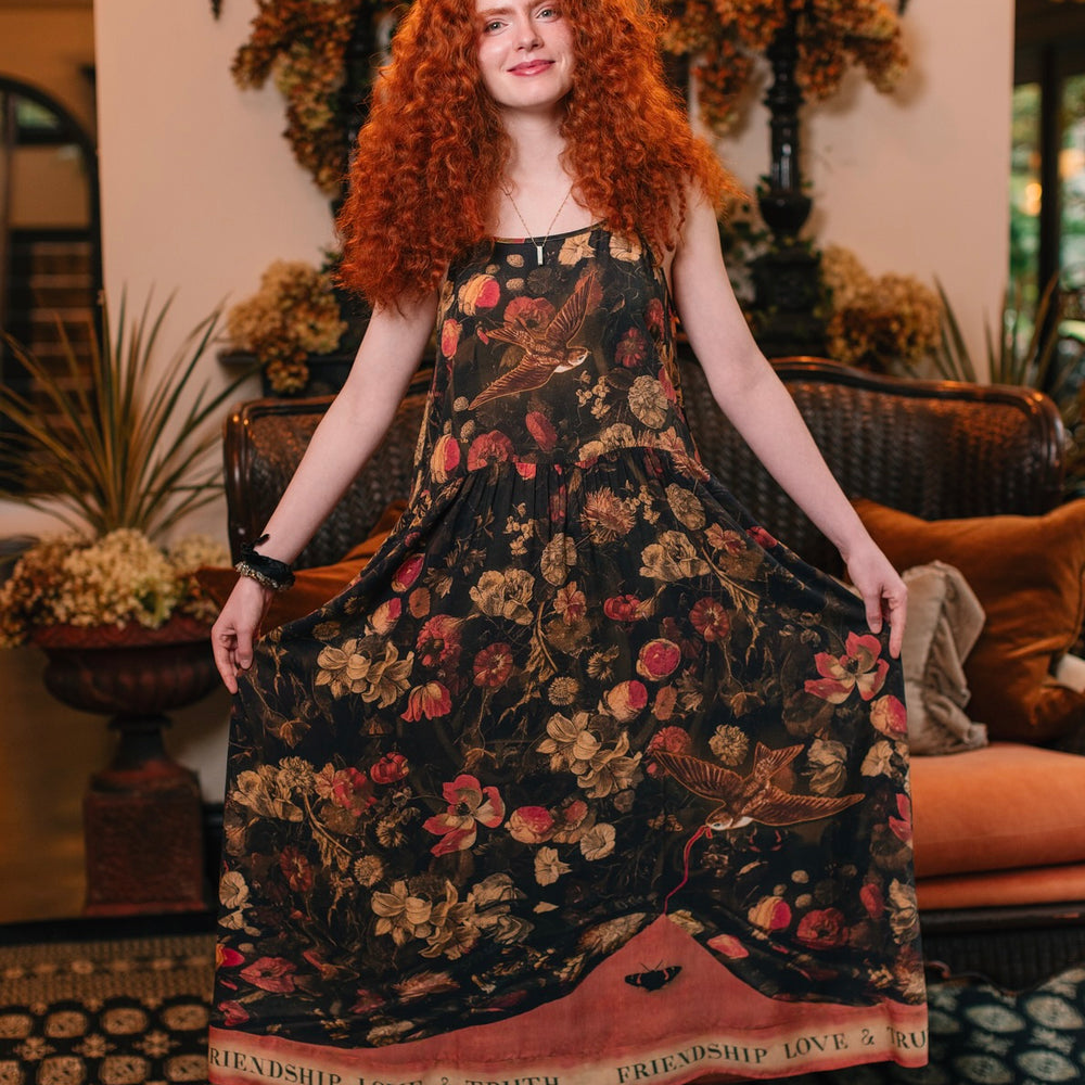 Model wearing a maxi-length bamboo-viscose slip dress featuring a collage of antique artwork with romance, loyalty, and old-world beauty - Market of Stars