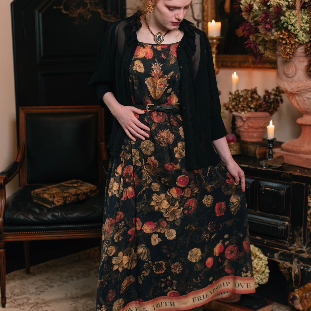 
                  
                    Model wearing a maxi-length bamboo-viscose slip dress featuring a collage of antique artwork with romance, loyalty, and old-world beauty - Market of Stars
                  
                