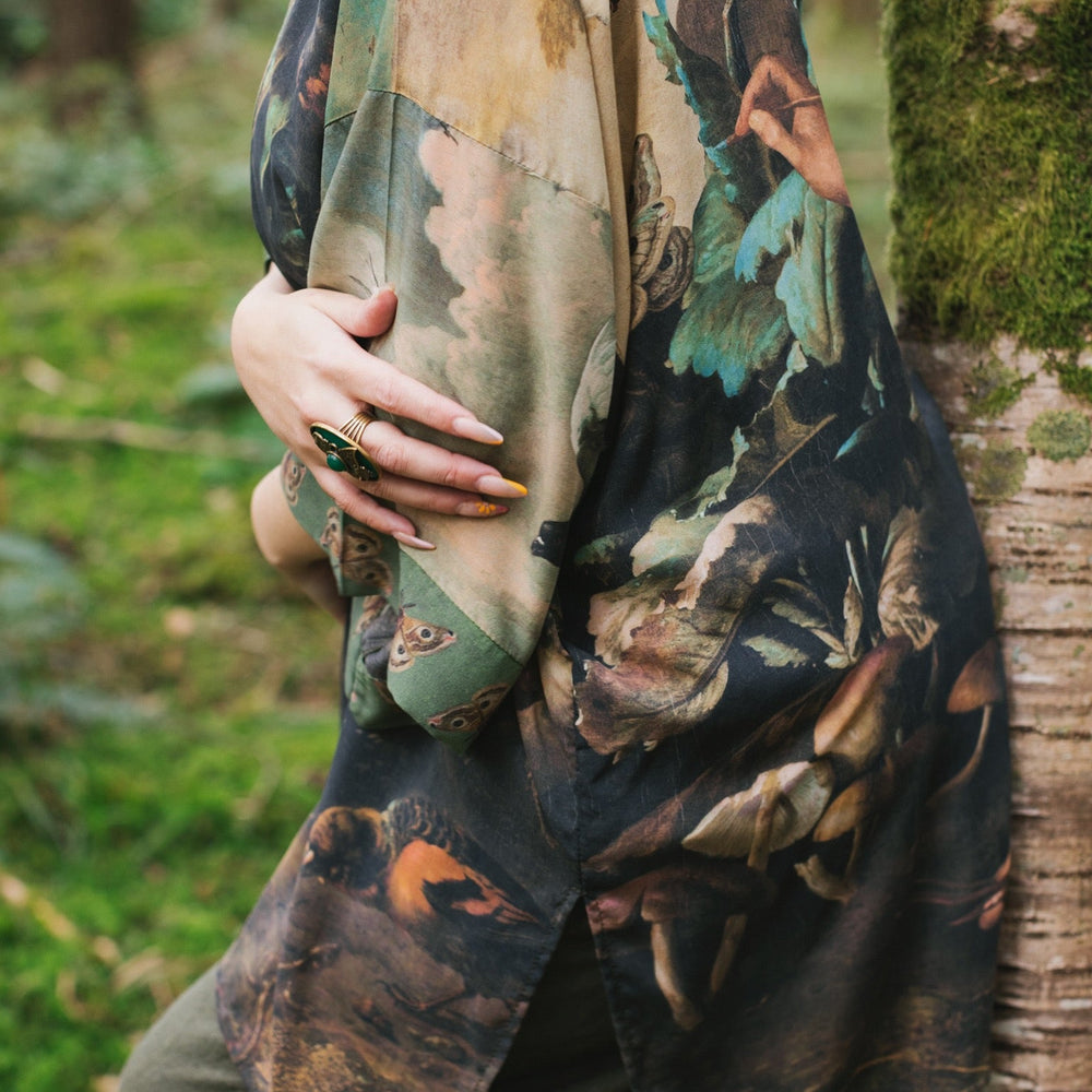 
                  
                    Model wearing the Heartwork Cropped Kimono featuring Artemisia Gentileschi’s self-portrait with lush forest, birds, and butterflies – Market of Stars.
                  
                