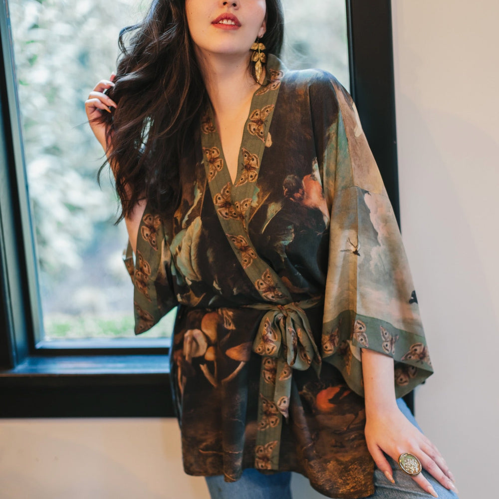 
                  
                    Model wearing the Heartwork Cropped Kimono featuring Artemisia Gentileschi’s self-portrait with lush forest, birds, and butterflies – Market of Stars.
                  
                