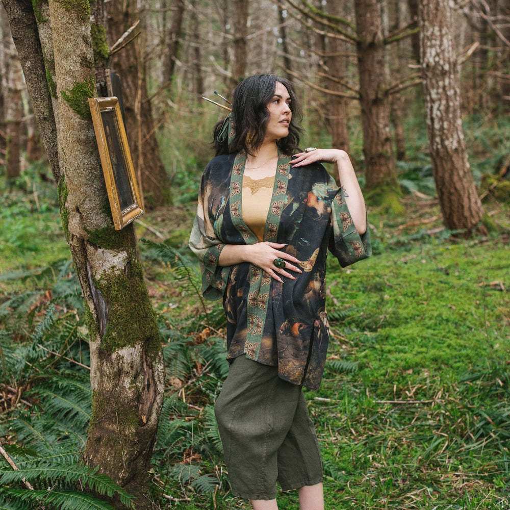 
                  
                    Model wearing the Heartwork Cropped Kimono featuring Artemisia Gentileschi’s self-portrait with lush forest, birds, and butterflies – Market of Stars.
                  
                