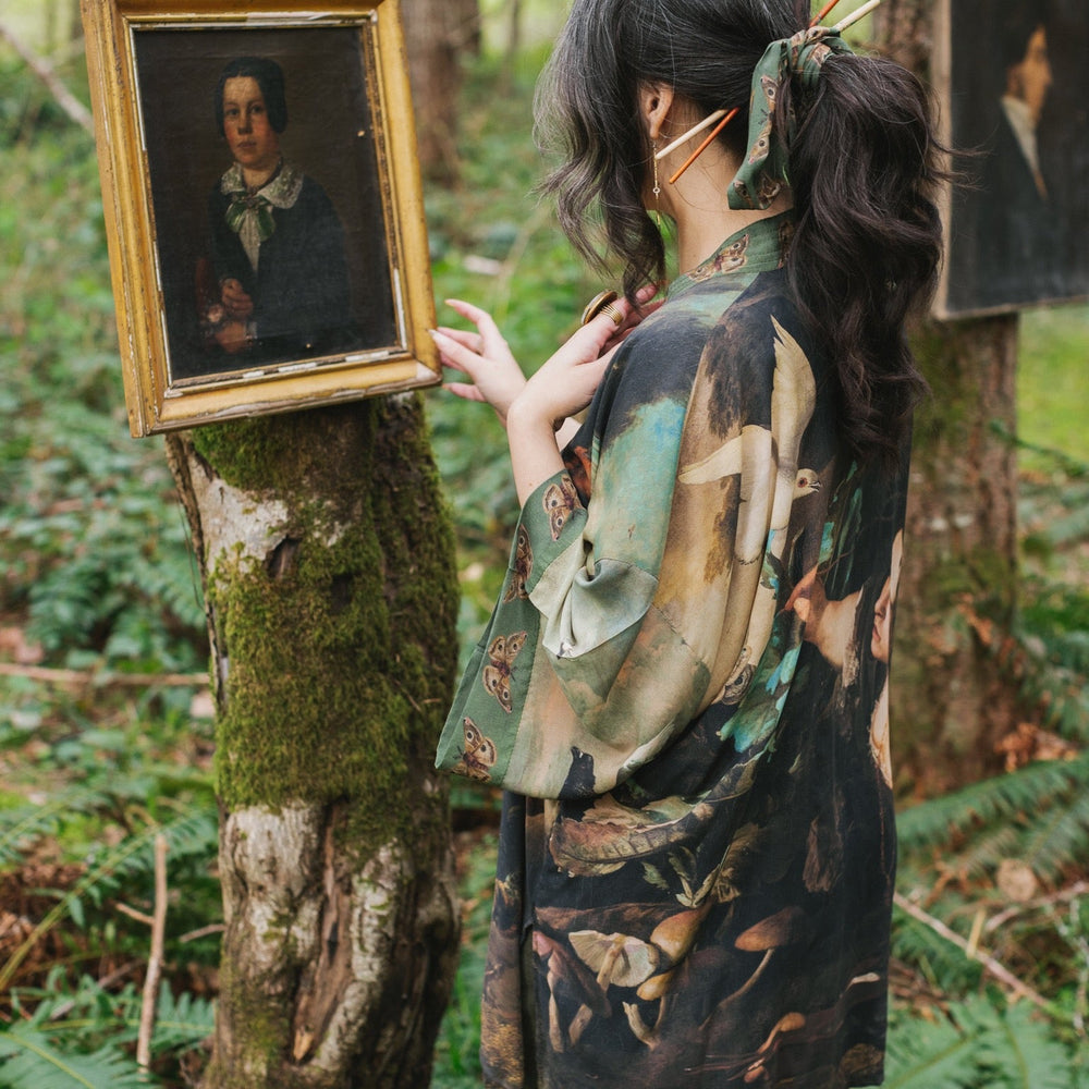 
                  
                    Model wearing the Heartwork Cropped Kimono featuring Artemisia Gentileschi’s self-portrait with lush forest, birds, and butterflies – Market of Stars.
                  
                