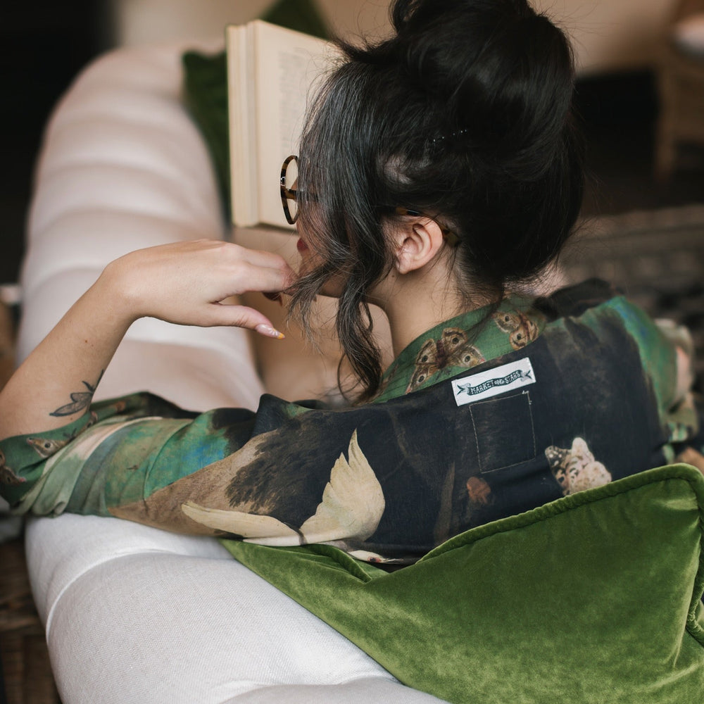 
                  
                    Model wearing the Heartwork Cropped Kimono featuring Artemisia Gentileschi’s self-portrait with lush forest, birds, and butterflies – Market of Stars.
                  
                