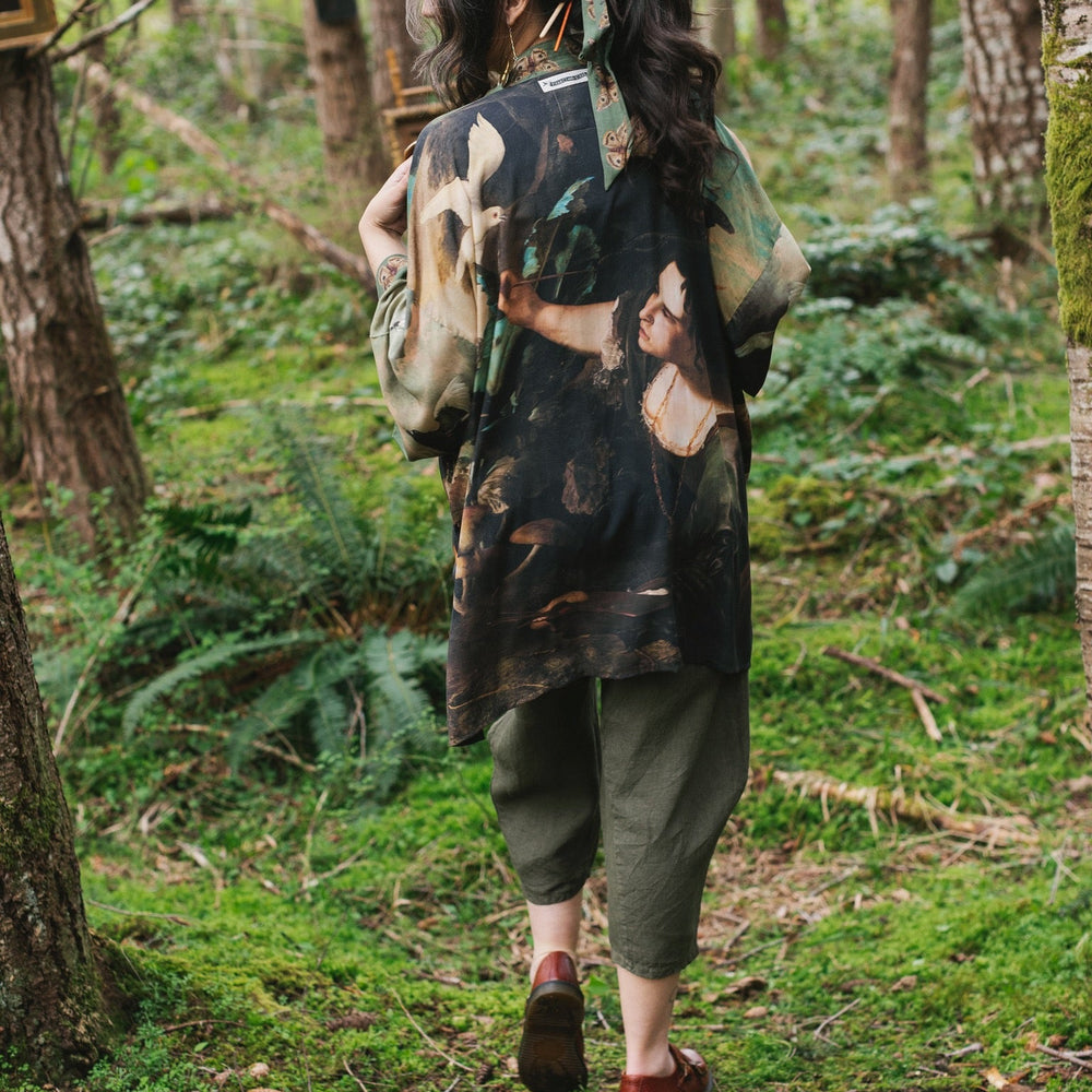 
                  
                    Model wearing the Heartwork Cropped Kimono featuring Artemisia Gentileschi’s self-portrait with lush forest, birds, and butterflies – Market of Stars.
                  
                