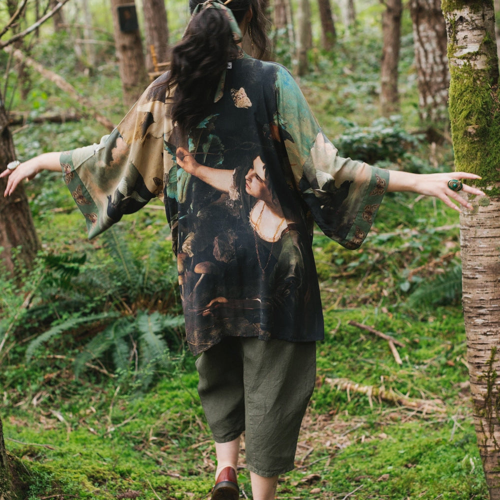 
                  
                    Model wearing the Heartwork Cropped Kimono featuring Artemisia Gentileschi’s self-portrait with lush forest, birds, and butterflies – Market of Stars.
                  
                