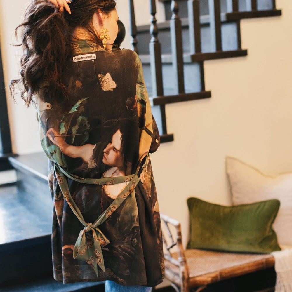 
                  
                    Model wearing the Heartwork Cropped Kimono featuring Artemisia Gentileschi’s self-portrait with lush forest, birds, and butterflies – Market of Stars.
                  
                