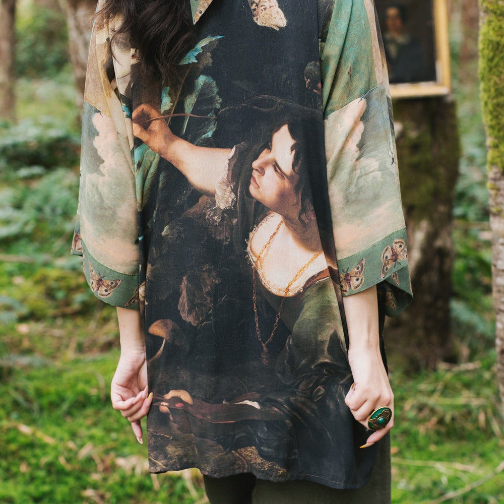 
                  
                    Model wearing the Heartwork Cropped Kimono featuring Artemisia Gentileschi’s self-portrait with lush forest, birds, and butterflies – Market of Stars.
                  
                