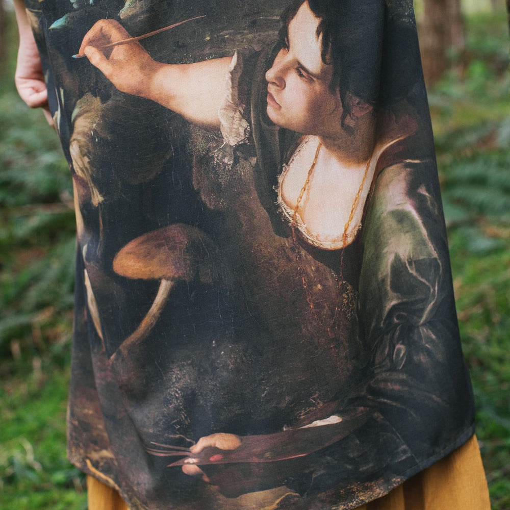 
                  
                    Model wearing the Heartwork Opera Duster featuring Artemisia Gentileschi’s self-portrait surrounded by forest, birds, and butterflies – Market of Stars.
                  
                