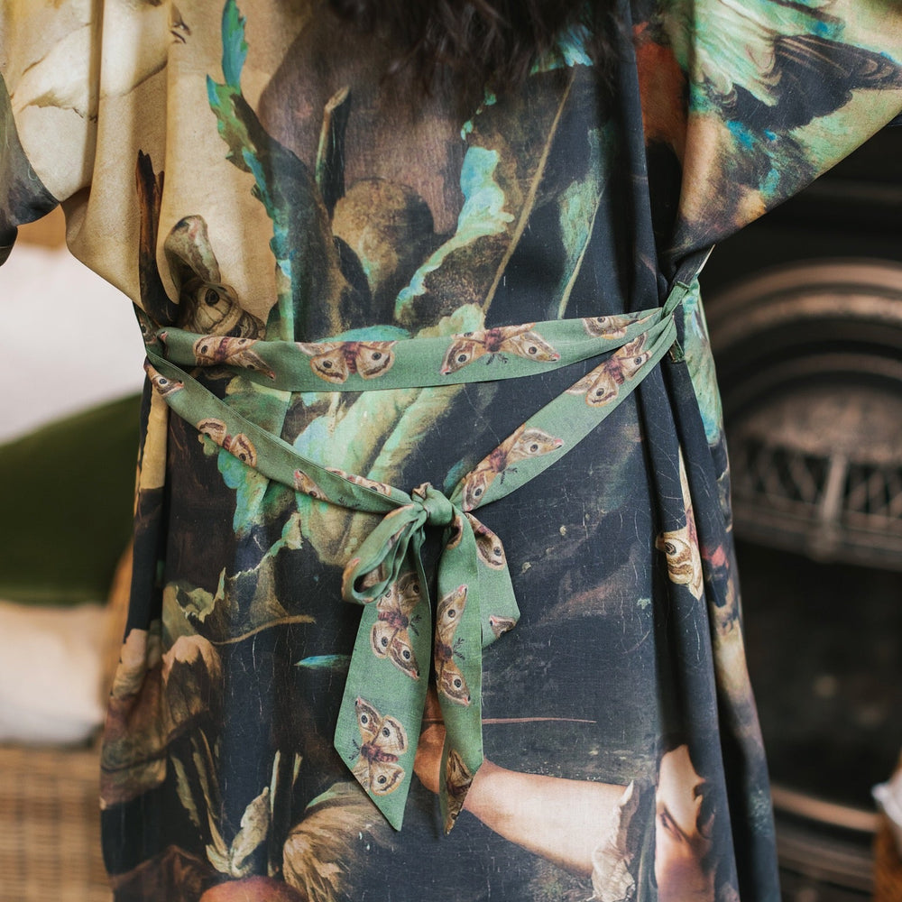 
                  
                    Model wearing the Heartwork Opera Duster featuring Artemisia Gentileschi’s self-portrait surrounded by forest, birds, and butterflies – Market of Stars.
                  
                