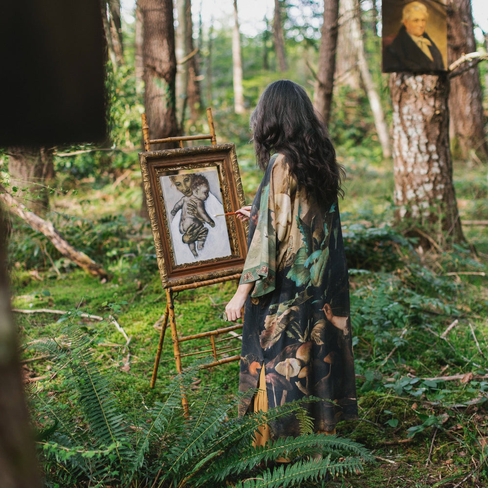 
                  
                    Model wearing the Heartwork Opera Duster featuring Artemisia Gentileschi’s self-portrait surrounded by forest, birds, and butterflies – Market of Stars.
                  
                