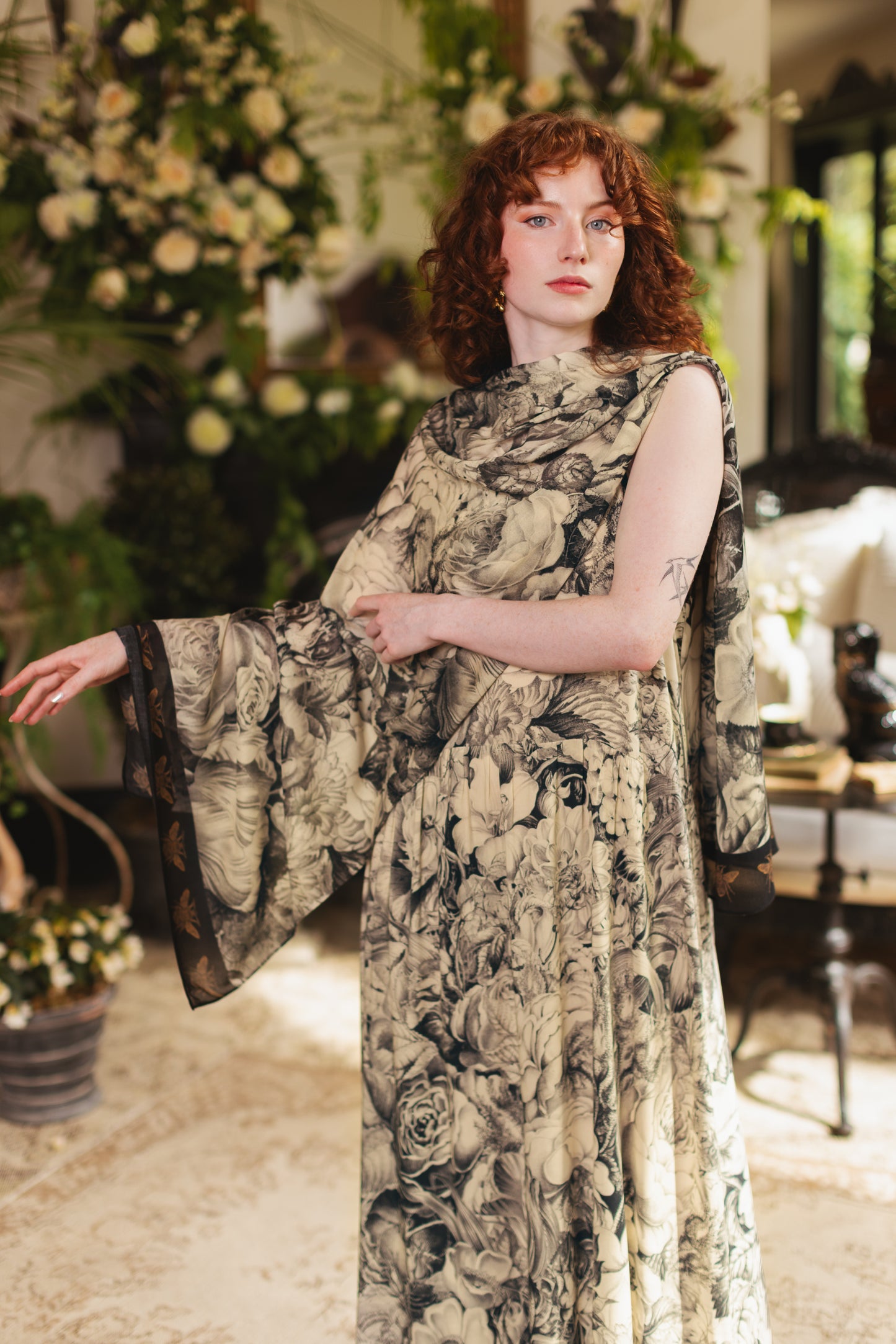 Model wearing a bamboo-viscose scarf featuring black-and-ivory floral lithographs from the 1900's - Market of Stars