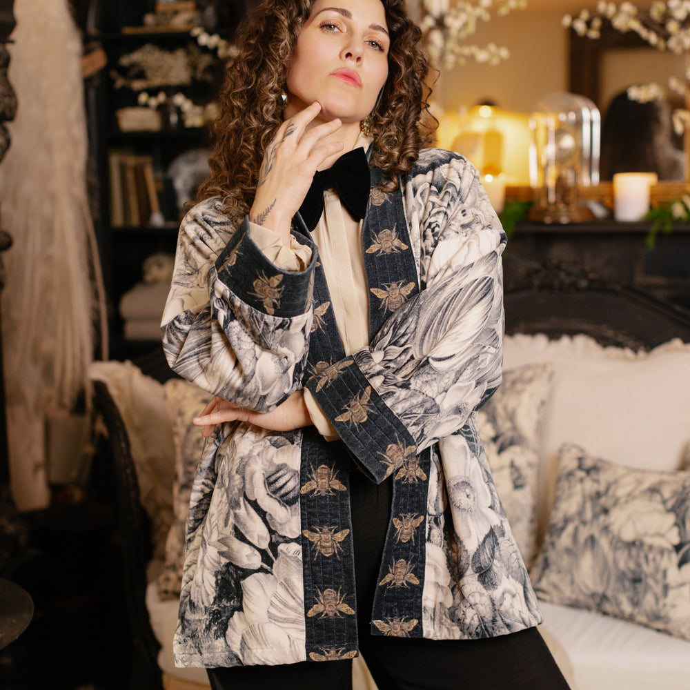 
                  
                    Model wearing a soft cotton velvet duster ft. 1900's floral lithographs. A garden dreamt up in ink - Market of Stars
                  
                